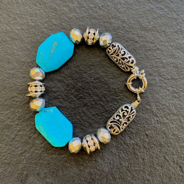 A bracelet made of Turquoise rectangles with silver crystals and antique silver beads with spring clasp