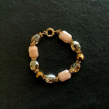 A bracelet made of Peach rectangular crystals with oval crystals & disco bead with spring clasp