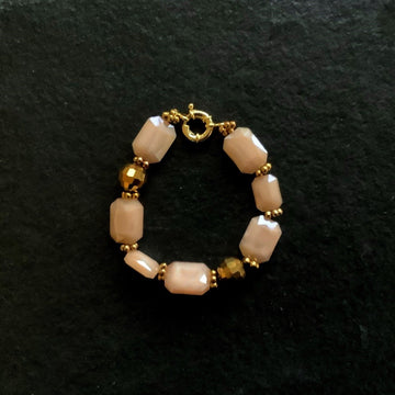 A bracelet made of Peach rectangular crystals with disco beads and  spring clasp