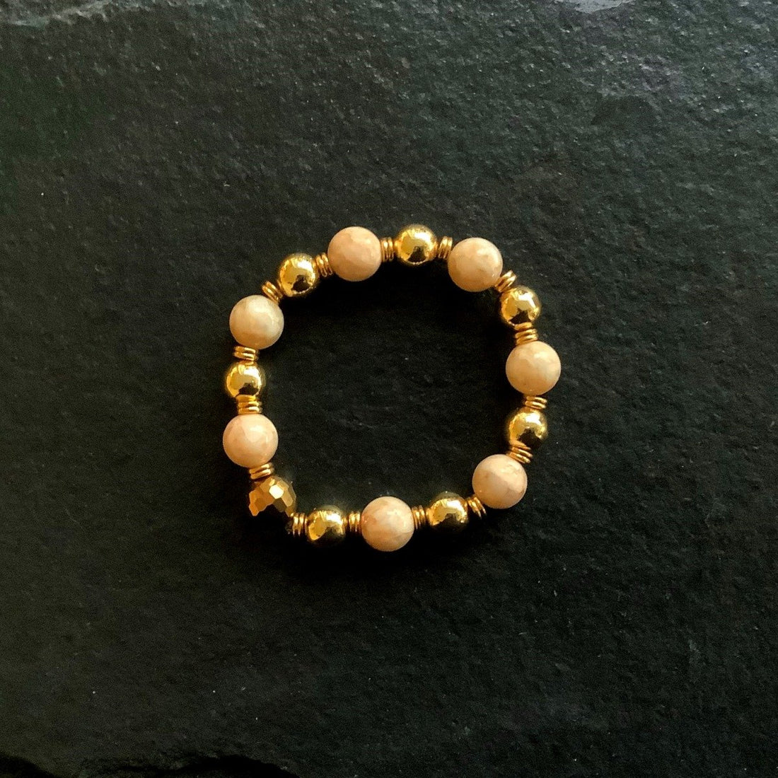 A bracelet made of Peachy shell pearls with rectangular peach crystals on elastic