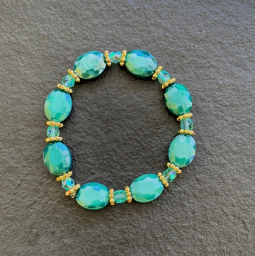A bracelet made of Turquoise crystal ovals with turquoise crystal rondels and gold accents