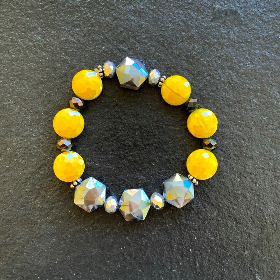 A bracelet made of Yellow & Gray crystals with metal and crystal rondels on elastic