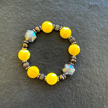 A bracelet made of Yellow & Gray crystals with crystal rondels on elastic