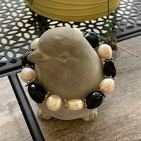 A bracelet made of Black Agates & fresh water pearls on elastic