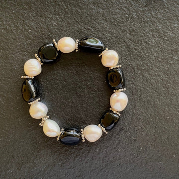 A bracelet made of Black Agates & fresh water pearls on elastic