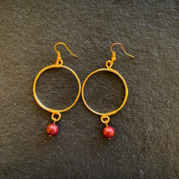 Earrings made of Mookaite round bead dangling from gold hoop