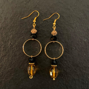 Earrings made of Gold crystal barrels with black rondels & hoop dangle