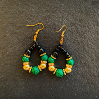 Earrings made of Malachite faceted beads in a teardrop with black & gold beads