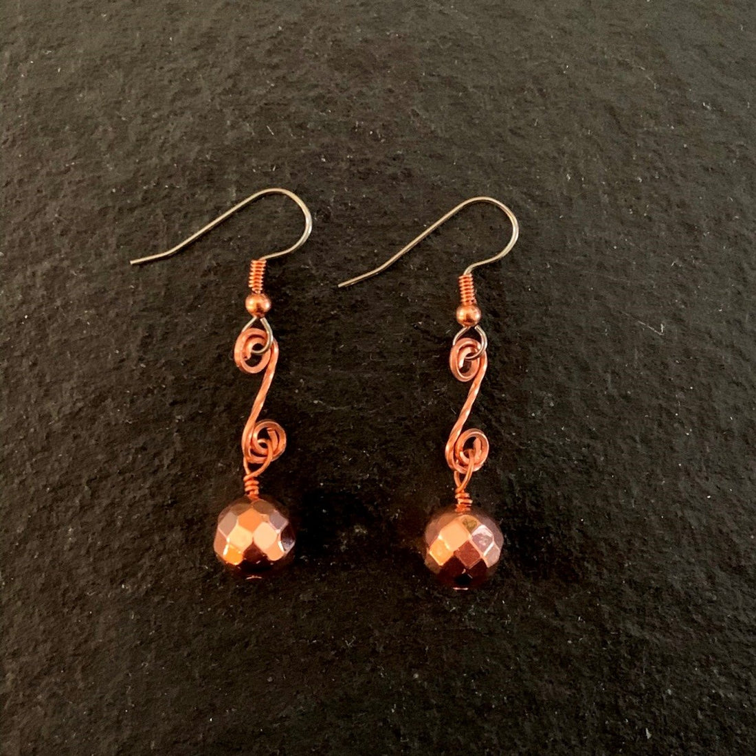Earrings made of Copper Disco beads on scrolled copper wire