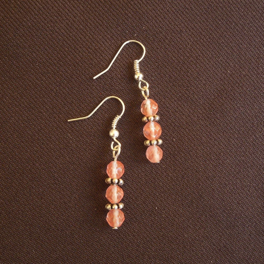 Earrings made of Small faceted cherry quartz rounds with silver accents