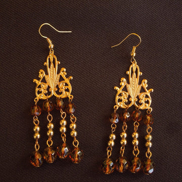 Earrings made of Tortoise Crystals with gold beads & chandelier base