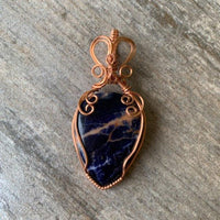 Pendant made of Sunset Sodalite teadrop with copper wrap; 1.25" w x 2 5/8" h, incl bail