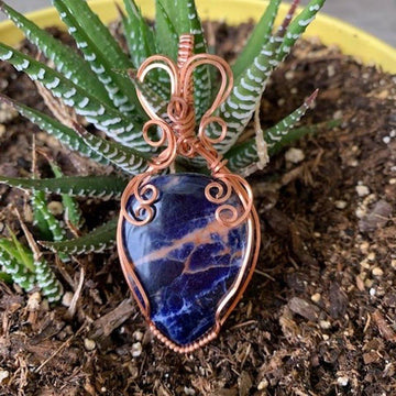 Pendant made of Sunset Sodalite teadrop with copper wrap; 1.25" w x 2 5/8" h, incl bail