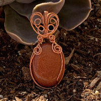 Pendant made of Golden Sunstone Oval Stone with Copper wire wrap; 1' w x 2 1/8" long, incl bail