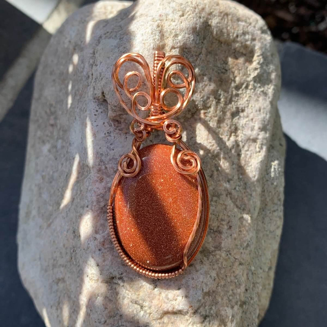 Pendant made of Golden Sunstone Oval Stone with Copper wire wrap; 1' w x 2 1/8" long, incl bail