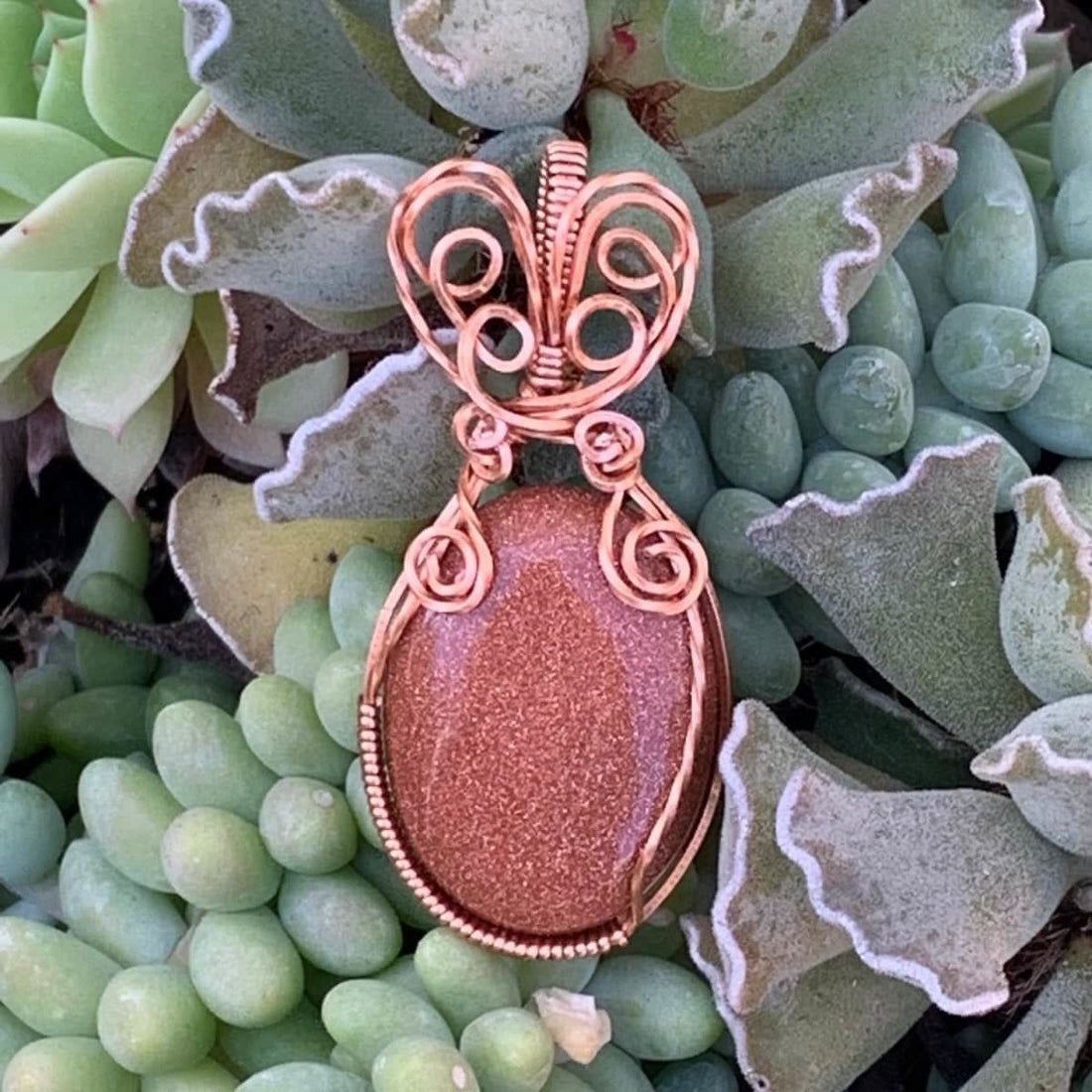 Pendant made of Golden Sunstone Oval Stone with Copper wire wrap; 1' w x 2 1/8" long, incl bail