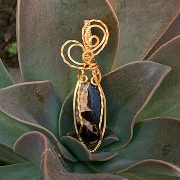 Pendant made of Ivory Copper Obsidian Oval stone with gold wire wrap; .5" w x 2" long, incl bail