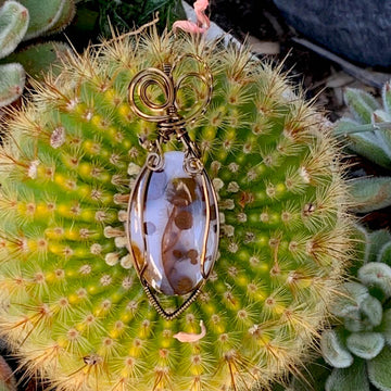 Pendant made of Large Polka Dot Jasper Oval stone with antique bronze wrap; 1" w x 2.75" long, incl bail