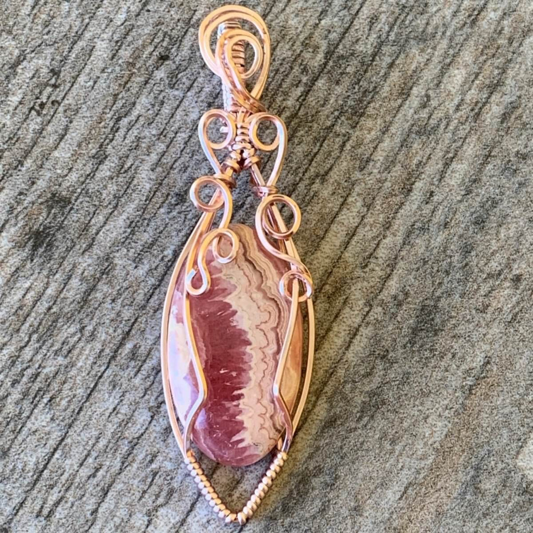 Pendant made of Rhodochrosite Oval stone with Rose Gold Wire Wrap; .75" w x 2.5" long, incl bail