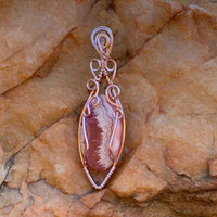 Pendant made of Rhodochrosite Oval stone with Rose Gold Wire Wrap; .75" w x 2.5" long, incl bail