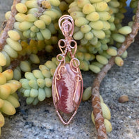 Pendant made of Rhodochrosite Oval stone with Rose Gold Wire Wrap; .75" w x 2.5" long, incl bail