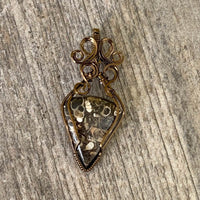 Pendant made of Turritella Triangle Agate with Bronze wire wrap; 1" w x 2 1/8" long incl bail