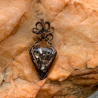 Pendant made of Turritella Triangle Agate with Bronze wire wrap; 1" w x 2 1/8" long incl bail