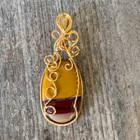 Pendant made of Mookaite Oval with gold wire wrap; 1"w x 25/8" long, incl bail