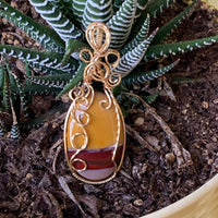 Pendant made of Mookaite Oval with gold wire wrap; 1"w x 25/8" long, incl bail