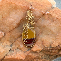 Pendant made of Mookaite Oval with gold wire wrap; 1"w x 25/8" long, incl bail