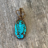 Pendant made of Turquoise oval Stone with bronze wire wrap; 7/8" w x 2.5" long incl bail