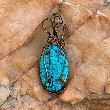 Pendant made of Turquoise oval Stone with bronze wire wrap; 7/8" w x 2.5" long incl bail