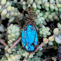 Pendant made of Turquoise oval Stone with bronze wire wrap; 7/8" w x 2.5" long incl bail