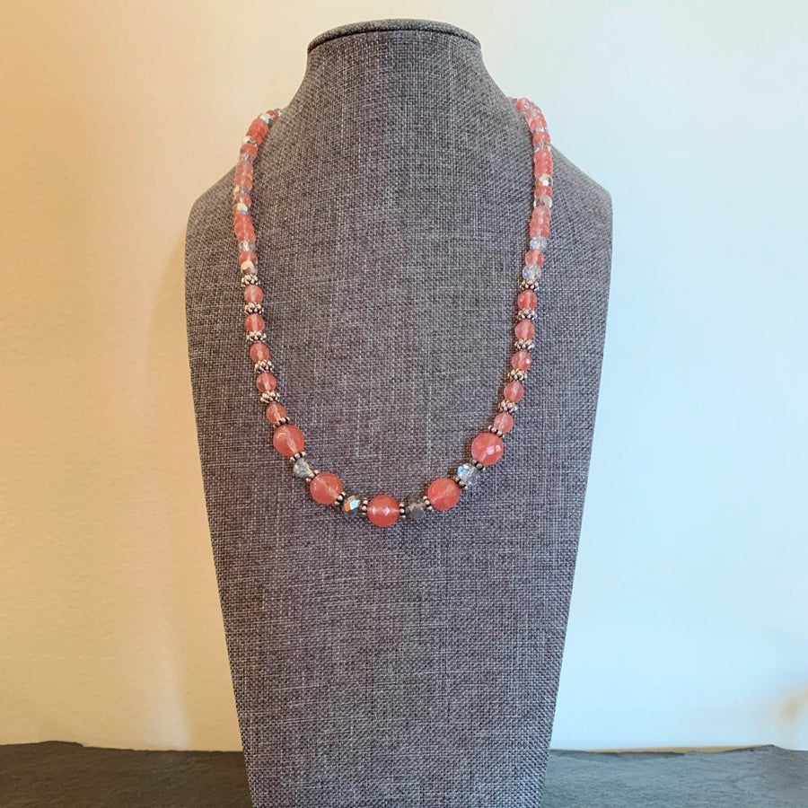 A necklace made of pink Cherry Quartz faceted beads with clear crystals.