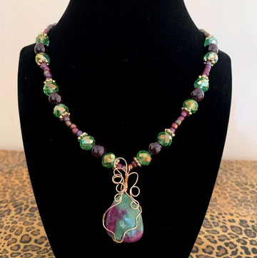 A necklace made of Green & Purple Ruby in Zoisite pendant with garnet beads and crystals