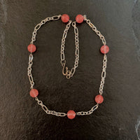 A necklace made of Cherry Quartz faceted beads on silver chain