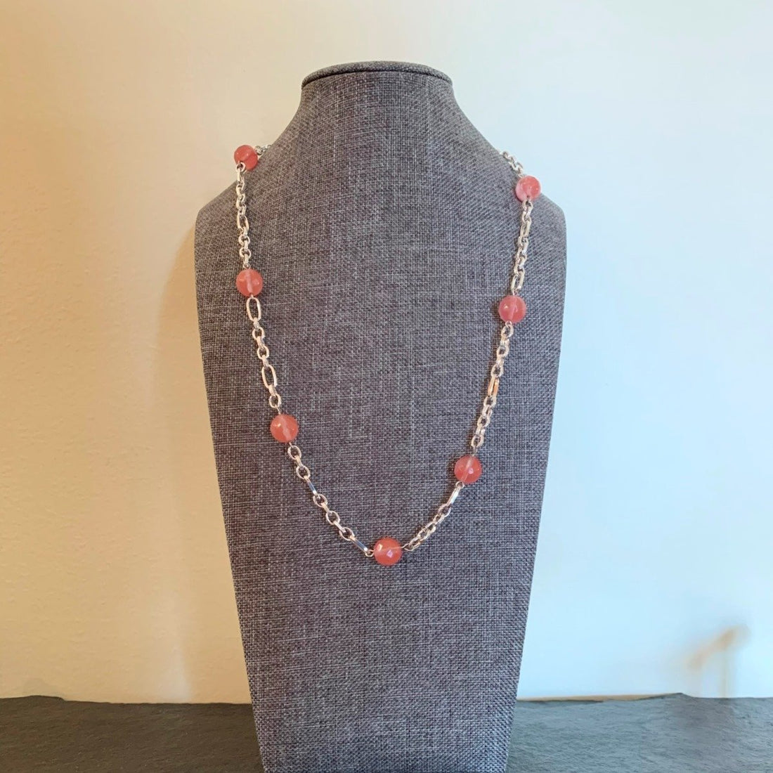 A necklace made of Cherry Quartz faceted beads on silver chain