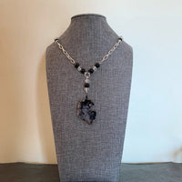 A necklace made of Black Tourmalated Quartz Geode w/clear cystals & black onyx beads