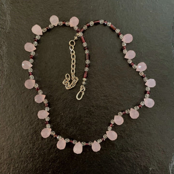 A necklace made of Rose Quartz teardrops with garnet & clear crystals