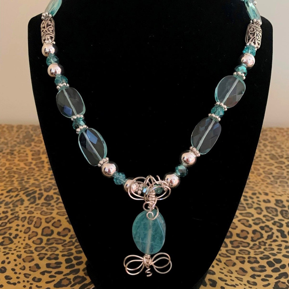 A necklace made of Aqua quartz faceted ovals w/turquoise crystals and silver beads