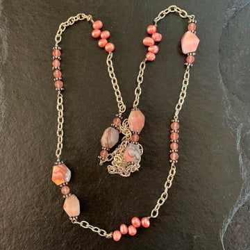 A necklace made of Botswana Pink Agates with pink pearls & rose quartz on silver chain