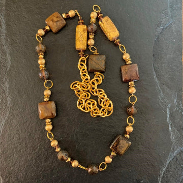 A necklace made of Bronzite square beads with gold florentine rounds on gold chain