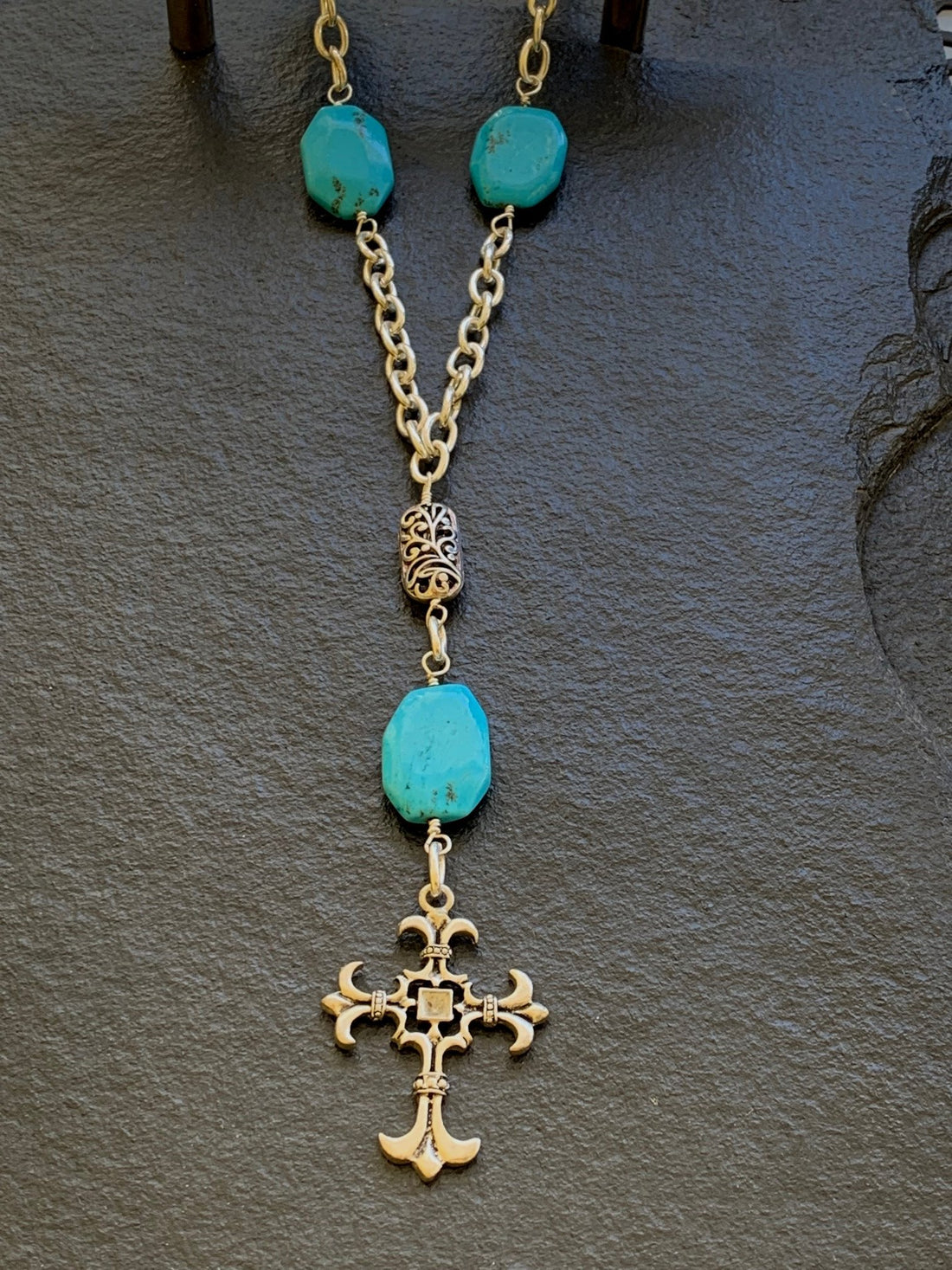 A necklace made of Turquoise Rectangles on silver chain with silver cross