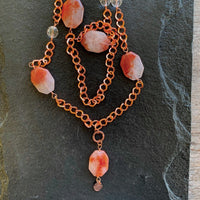 A necklace made of Large dendritic carnelian quartz on Copper chain with clear crystals