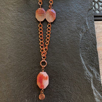 A necklace made of Large dendritic carnelian quartz on Copper chain with clear crystals