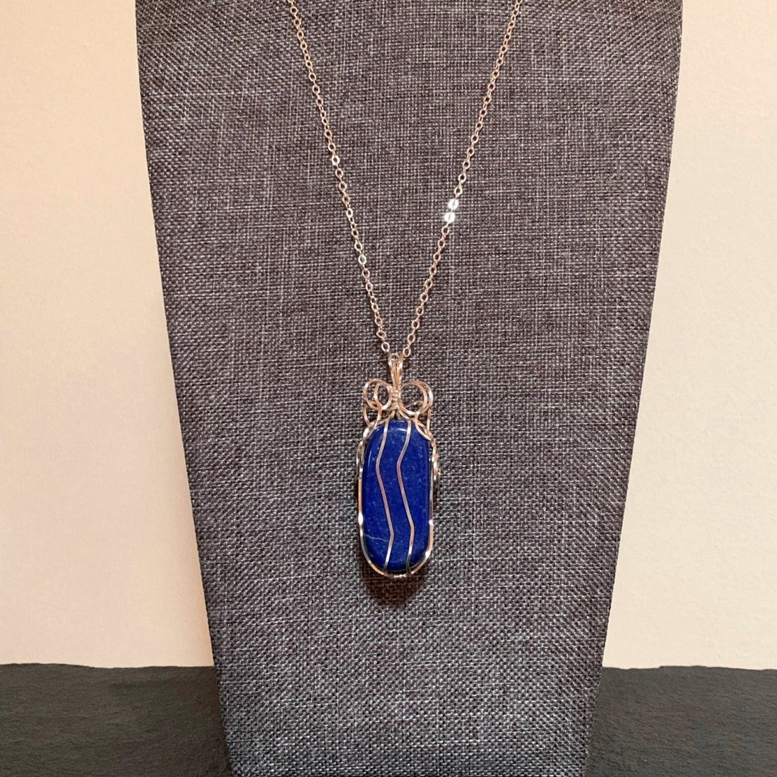 Pendant made of Blue Rectangle Lapis Lazuli stone w/ silver wrap; .75" x 2.1" incl bail