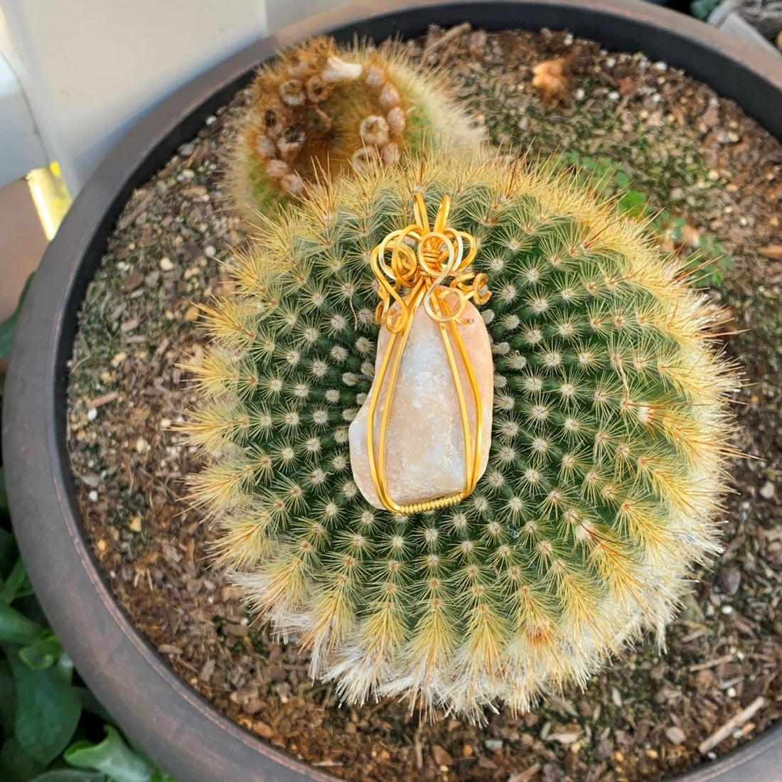 Pendant made of Beige Confusious with gold wire; 1.25" w x 2.25 h" incl bail