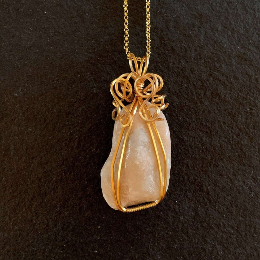 Pendant made of Beige Confusious with gold wire; 1.25" w x 2.25 h" incl bail