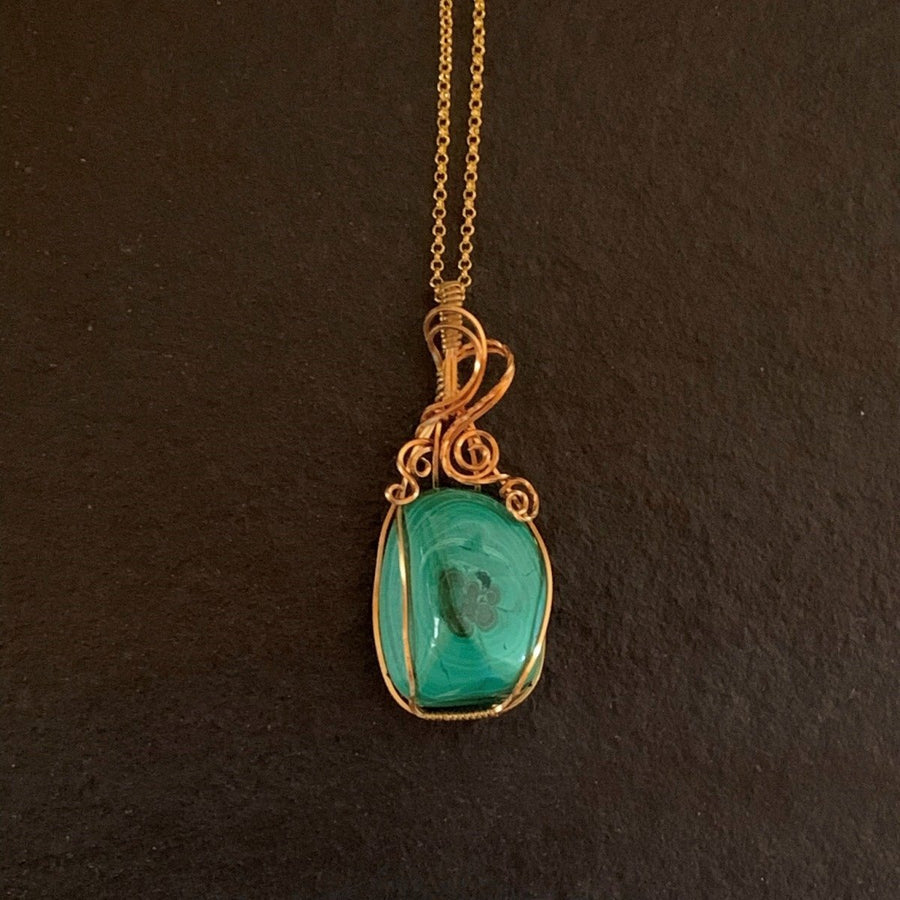 Pendant made of Green Malachite stone with gold wire wrap; 1" w x 2.5" h incl bail