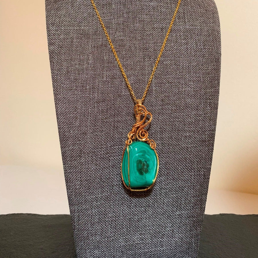 Pendant made of Green Malachite stone with gold wire wrap; 1" w x 2.5" h incl bail